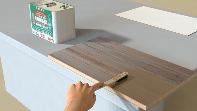 ランバーコア合板に速乾ボンドを塗っている